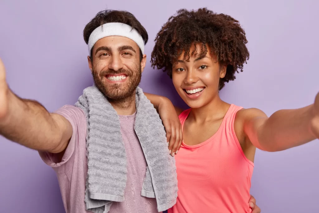 smiling man and woman posing after exercise utc